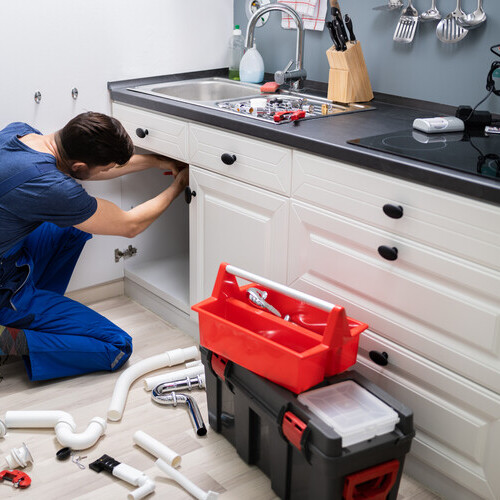 plumber installing a kitchen sink